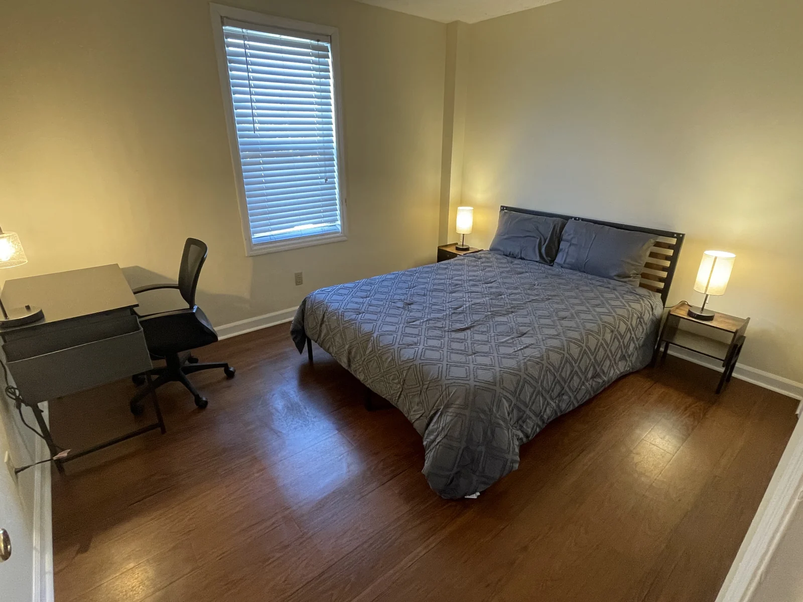 A restful bedroom in the furnished Midtown Nashville condo